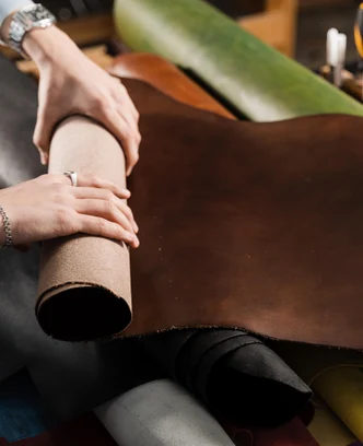 ac1f45a8-2fe8-43c5-b2b8-bc175e710b4a-leather-craftsman-is-touching-roll-genuine-leather-workshop-rolls-genuine-leather-different-colors-leather-products-workshop.jpg